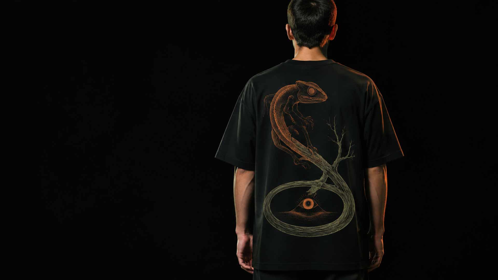 Reptile keeper wearing a Hellish Reptiles T-shirt with a snake print on the back